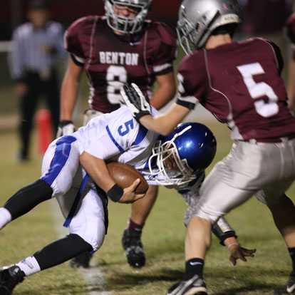 Bryant quarterback Gunnar Burks (5) lunges forward in front of Benton's Zach Whittamore (5) and Drew Dyer (8). (Photo by Rick Nation)