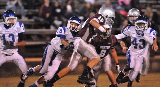 Nick Hardin (16) tries to bring down Benton's Colton Nix (10) as Khaliq Slater (43) and Jaelyn Jones (13) arrive to help. (Photo by Kevin Nagle)