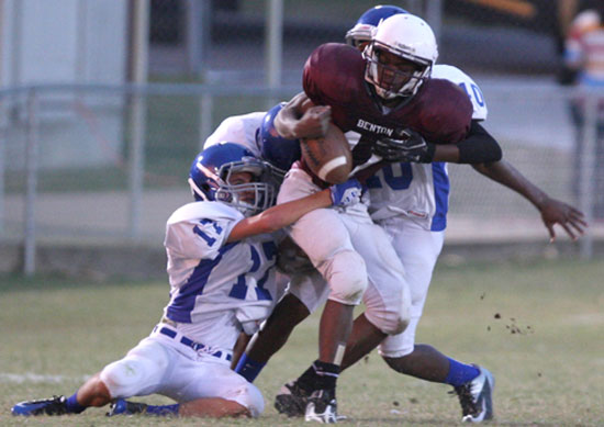 Jassim Lee (17) and Marvin Moody (40) knock the ball loose from Benton's Brandon Hunter. (Photo by Rick Nation)