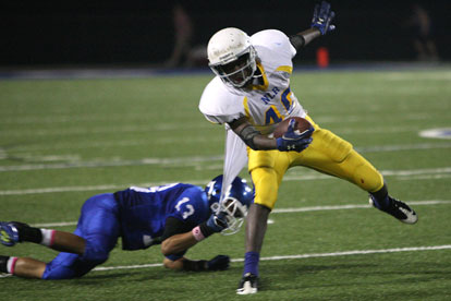 Jaelyn Jones (13) holds on to a piece of Dontez Batchelor's jersey. (Photo by Rick Nation)