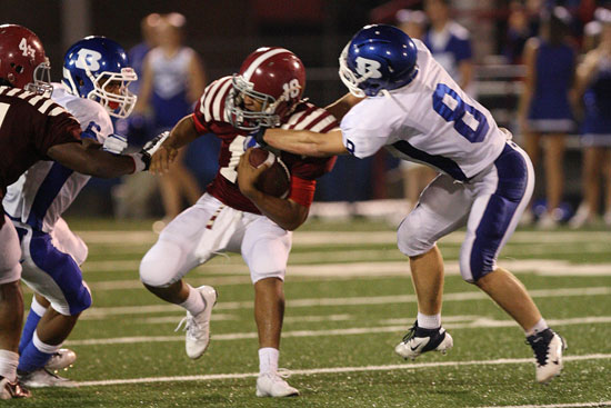 Bryant's Davis Nossaman (8) latches onto Pine Bluff quarterback Brandon Starks (10) as teammate Brenden Young (6) arrives to help. (Photo by Rick Nation)