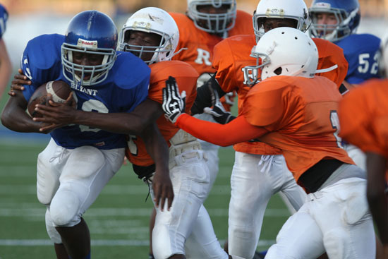 Cameron Coleman tries the break through a flock of Ridge Road Rams. (Photo by Rick Nation)