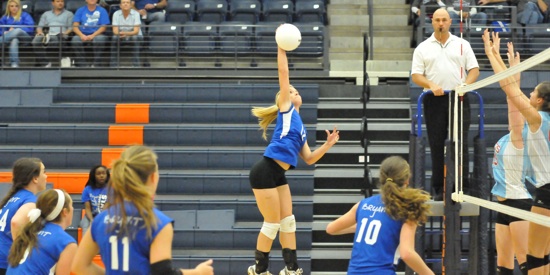 McKenzie Rice spikes the ball as teammates, from left, Brooke Howell, Brittan Hays, Hannah Rice and Alyssa Anderson get in position. (Photo by Kevin Nagle)