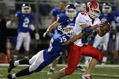 Jake Johnson tackles a Cabot receiver. (Photo by Rick Nation)