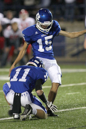 Josh Lowery boots an extra point out of the hold of Austin Vail. (PHoto by Rick Nation)