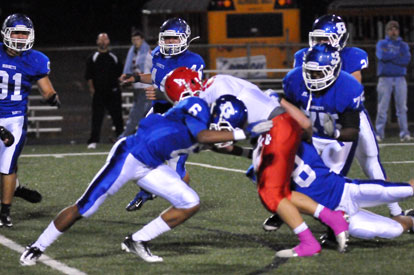 Bryant's Brendan Young (6) and Davis Nossaman (8) bring down Cabot quarterback Kason Kimbrell as help arrives from Cortez Williams (75) and Bryce Denker. (Photo by Kevin Nagle)