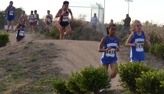 Bryant's Melinda Murdock and Hannah Raney lead a pack of runners past a hilly section of the cross country course in Rogers.(Photo courtesy of Julie Shelby)