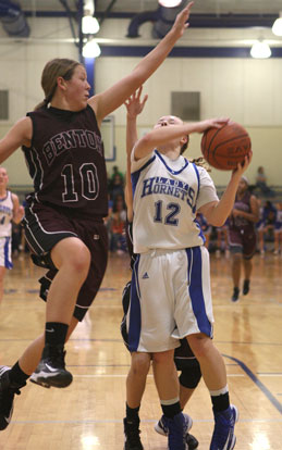 Bryant's Skylar Davis (12) tries to get a shot past Benton's Taylor Oglesby. (Photo by Rick Nation)