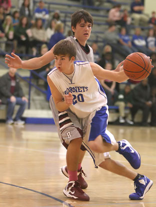 Evan Lee drives around a Benton defender. (Photo by Rick Nation)