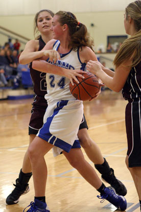 Bryant's Britney Sahlmann (24) protects the ball against a pair of Benton defenders. (Photo by Rick Nation)