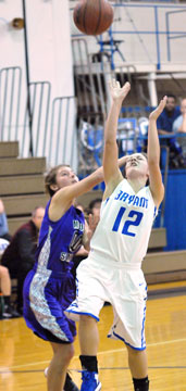 Madeleine Baxter (12) gets rapped on the head as she shoots. (Photo by Kevin Nagle)