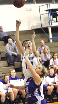 Destiny Huffman takes a shot over Mount St. Mary's Cassie Sloan. (Photo by Kevin Nagle)