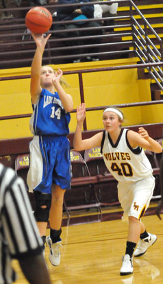 Riley Hill (14) launches a shot from the baseline as Skylar Foster defends. (Photo by Kevin Nagle)