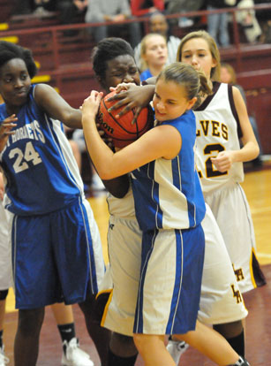 Sarah Kennedy and teammate Penny Smith (14) try to wrestle possession away from Lake Hamilton's Nickiyah Hudson. (Photo by Kevin Nagle)