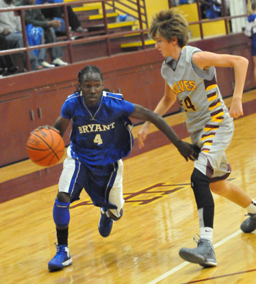 Bryant's Simeon Watson works his way around a Lake Hamilton defender. (Photo by Kevin Nagle)