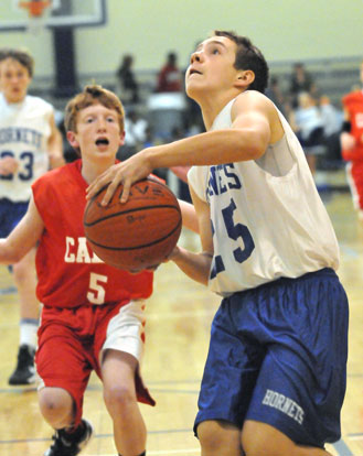 Tristan Calhoun drives to the basket. (Photo by Kevin Nagle)