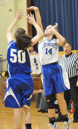 Riley Hill (14) follows through on her jumper. (Photo by Kevin Nagle)