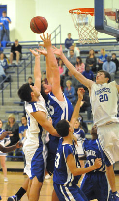 Clay Ingold and Evan Lee (20) fight for a rebound. (Photo by Kevin Nagle)