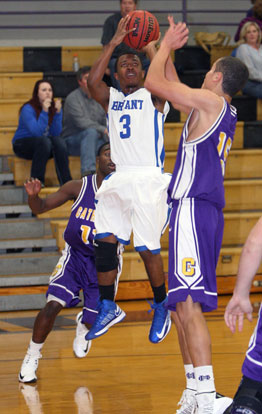 C.J. Rainey (3) fires a shot over Catholic's Corey Smith. (Photo by Rick Nation)