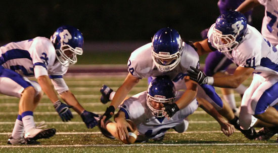 The only turnover of Friday's game, Hornets Hunter Fugitt (34) recovered the loose ball but Drew Tipton (25), Tim Kelly (91) and Ben Bruick (17) were there. (Photo by Rick Nation)