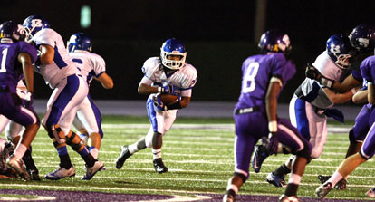 Jalen Bell takes off through a gaping hole produced by his offensive line. (Photo by Rick Nation)