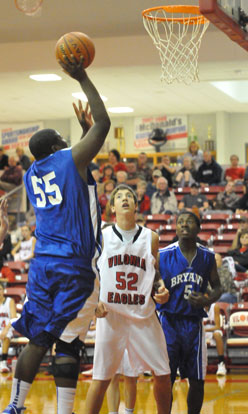 Cameron Murray (55) shoots over Vilonia's Charlie Thomas and Bryant's Quin Royal. (Photo by Kevin Nagle)