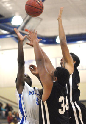 Kris Croom puts up a shot over a pair of Maumelle defenders. (Photo by Kevin Nagle)