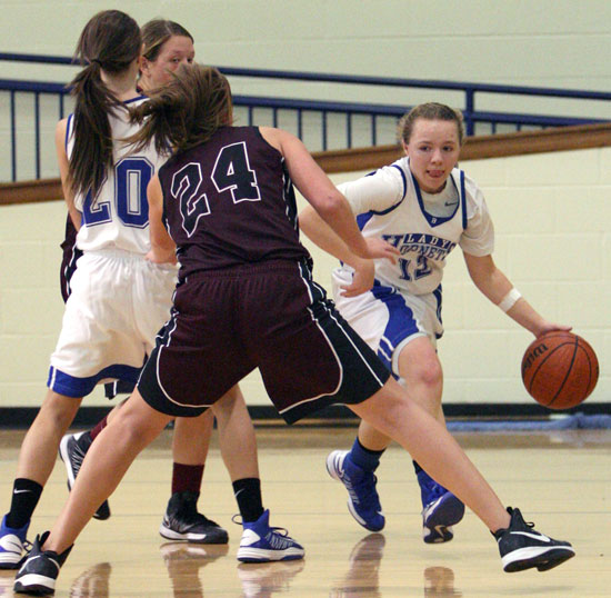 Bryant point guard Skyar Davis works around a screen set by teammate Kailey Nagle (20) as Benton's Jazmine Rodgers (24) defends. (Photo by Rick Nation)