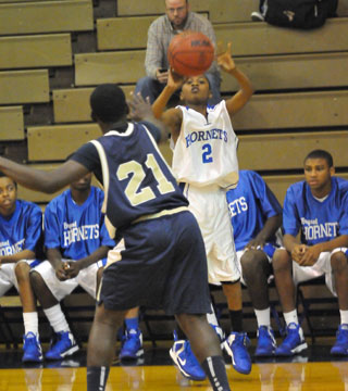 Bryant's Alex Oneal launches a shot over Pulaski Academy's Isiah Woods. (Photo by Kevin Nagle)