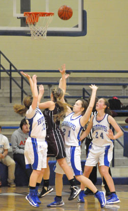 Skylar Davis and Annie Patton (21) defend as Benton's Abby Clay puts up a shot. (Photo by Kevin Nagle)