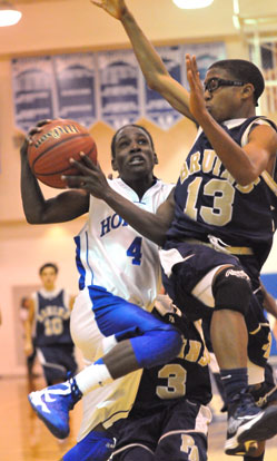 Bryant's Simeon Watson (4) takes the ball to the hoop against a Pulaski Academy defender. (Photo by Kevin Nagle) 