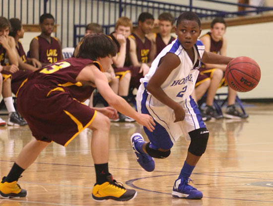 Bryant's Alex Oneal (2) is tracked by Lake Hamilton's Parker Knapp during Thursday's contest. (Photo by Rick Nation)