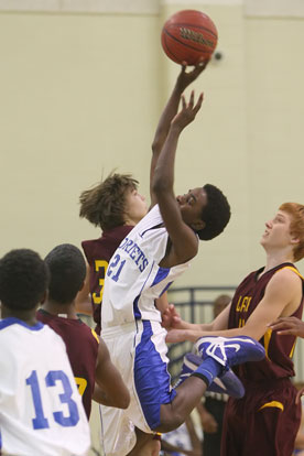 Quinton Royal (21) puts up a shot in the lane. (Photo by Rick Nation)