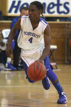 Simeon Watson pushes the ball into the front court. (Photo by Rick Nation)