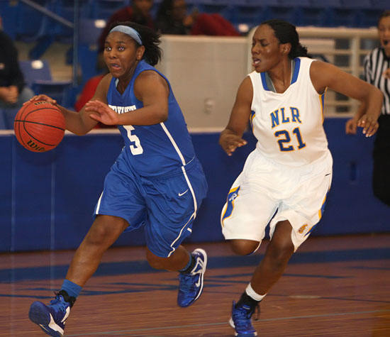 Bryant's Dezerea Duckworth (5) drives past North Little Rock's Jasmin Mays. (Photo by Rick Nation)