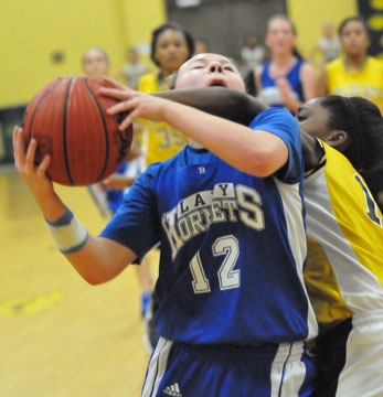 Skylar Davis gets hacked on her way to a shot. (Photo by Kevin Nagle)