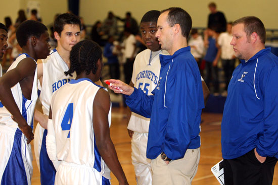 Coaches Mike Simmons and Brett Haugh talk strategy during a timeout. (Photo by Rick Nation)