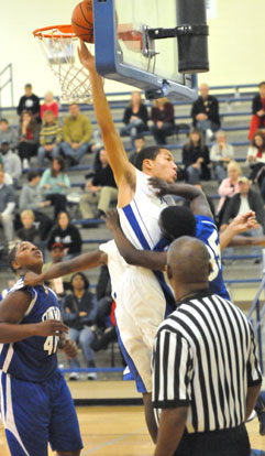 Though he was called for a foul, Bryant's Jaelynn Jones swatted this shot by Zan Thomas (35). (Photo by Kevin Nagle)