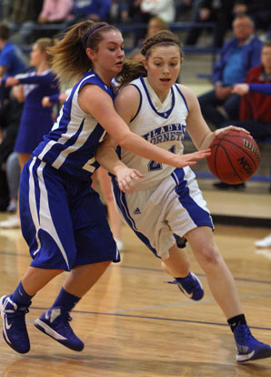 Bryant's Annie Patton drives on Conway Blue's Heather Lumley. (Photo by Rick Nation)