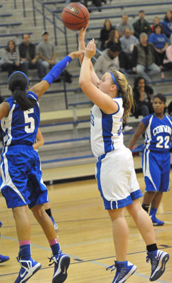 Anna Turpin fires up a shot over Conway Blue's Alexis Tolefree. (Photo by Kevin Nagle)