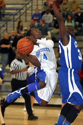 Simeon Watson (4) eyes the basket as he drives on Conway Blue's Zan Thomas. (Photo by Rick Nation)