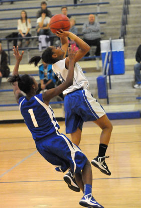 Bryant White's Destiny Martin (21) drives for a layup. (Photo by Kevin Nagle)