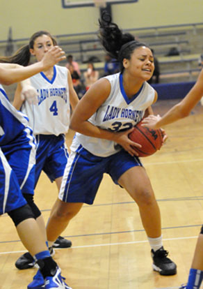 Kennedy Harris secures a rebound in front of teammate Hadley Dickinson. (Photo by Kevin Nagle)