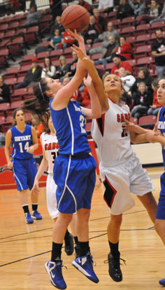 Courtney Davidson, left, gets hit on the arm as she goes up for a shot. (Photo by Kevin Nagle)
