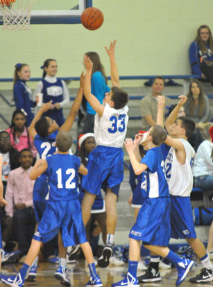 Brooks Ellis puts up a shot over Bryant Blue's Brandon Shirlee (23) and Sam Chumley (12). (Photo by Kevin Nagle)