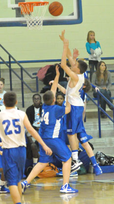 Grayson Prince (42) tries to score over Bryant Blue's Preston Kyzer (34). (Photo by Kevin Nagle)