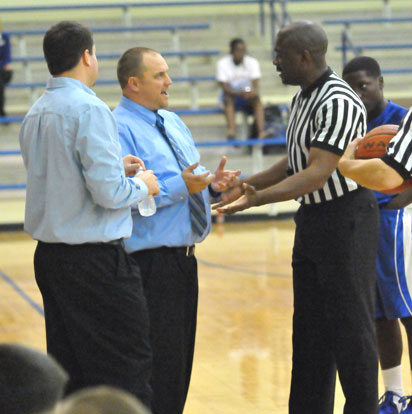 Bryant White coach Heath Long, left, and Bryant Blue coach Derek McGrew discuss a scorebook discrepency with one of the officials Monday night. (Photo by Kevin Nagle)