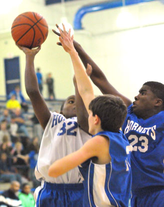 Bryant White's Jonathan Allen goes up for a shot over Bryant Blue's Hunter Handly and Phillip Isom-Green (23). (Photo by Kevin Nagle)