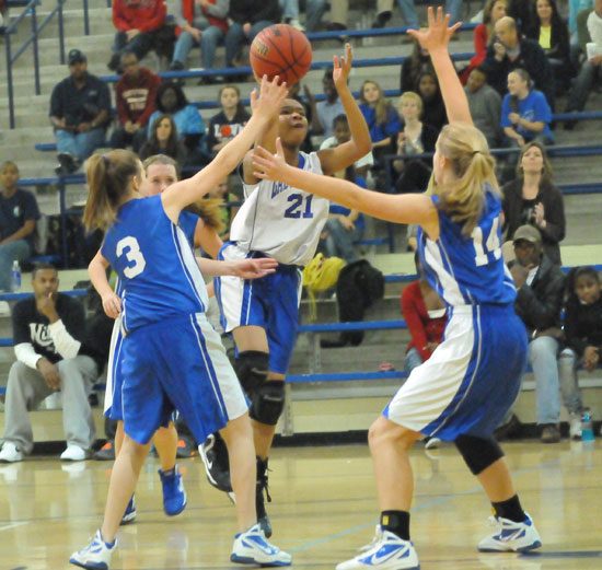 Bryant White's Destiny Martin goes up for a jumper in front of Bryant Blue's Bethany Hutchison (3) and Riley Hill (14). (Photo by Kevin Nagle)