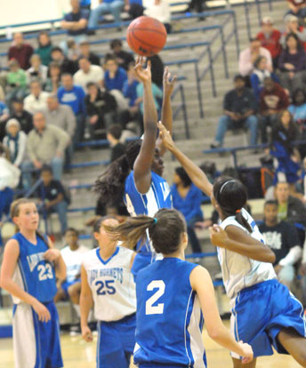 Bryant Blue's Penny Smith goes up for a shot in the lane as Bryant White's Lanie Ratliff defends in front of Kendal Rogers (23), Macey Jaramillo (25) and Kasey Ward (2). (Photo by Kevin Nagle)